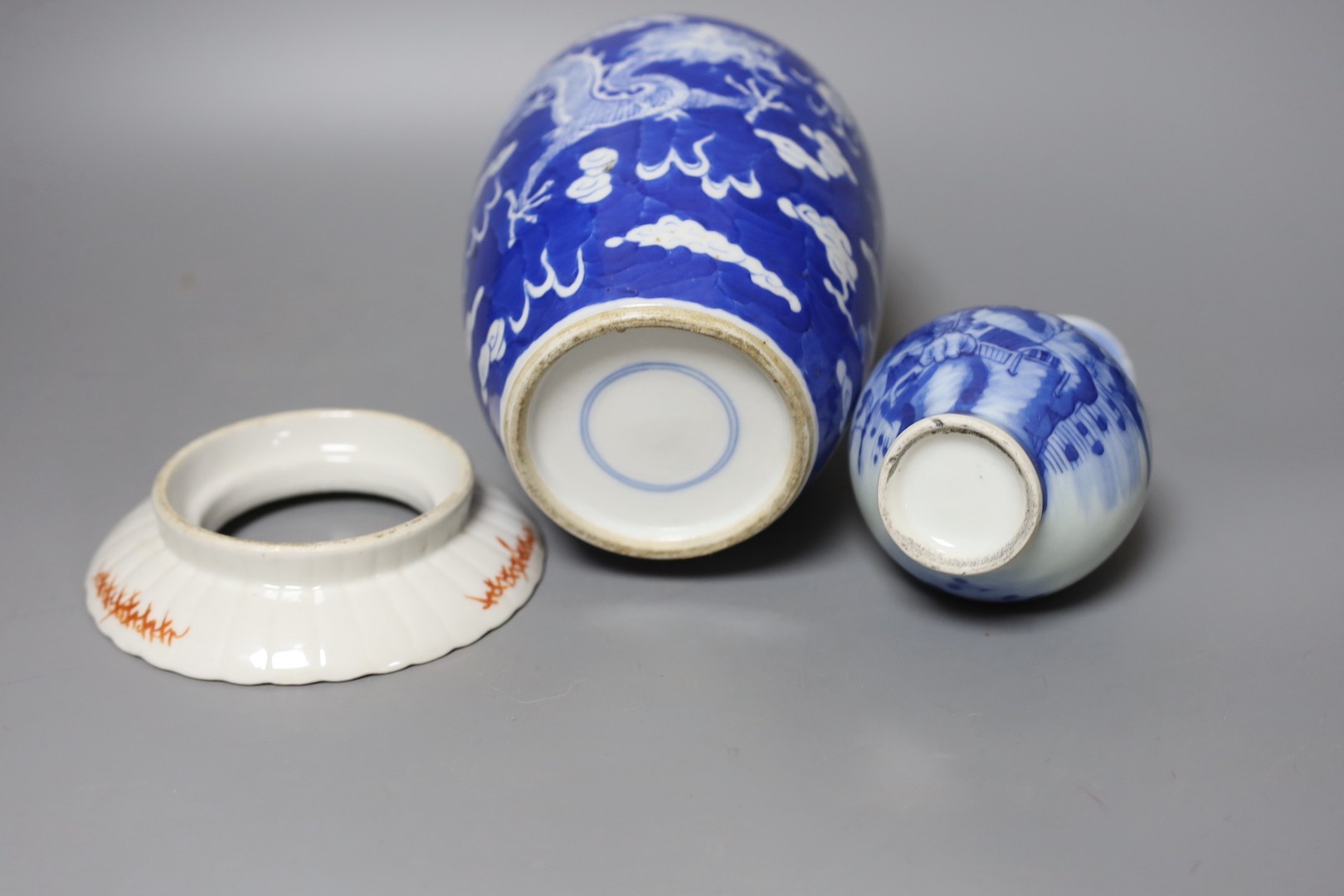 A 19th century Chinese famille rose rice bowl, cover and stand, together with a blue and white dragon jar and similar bottle vase. Largest 18cm